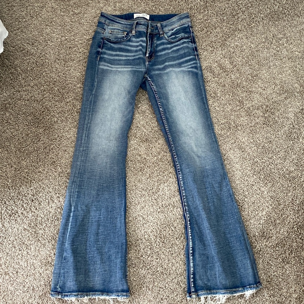 Buckle mid rise flare jeans distressed
